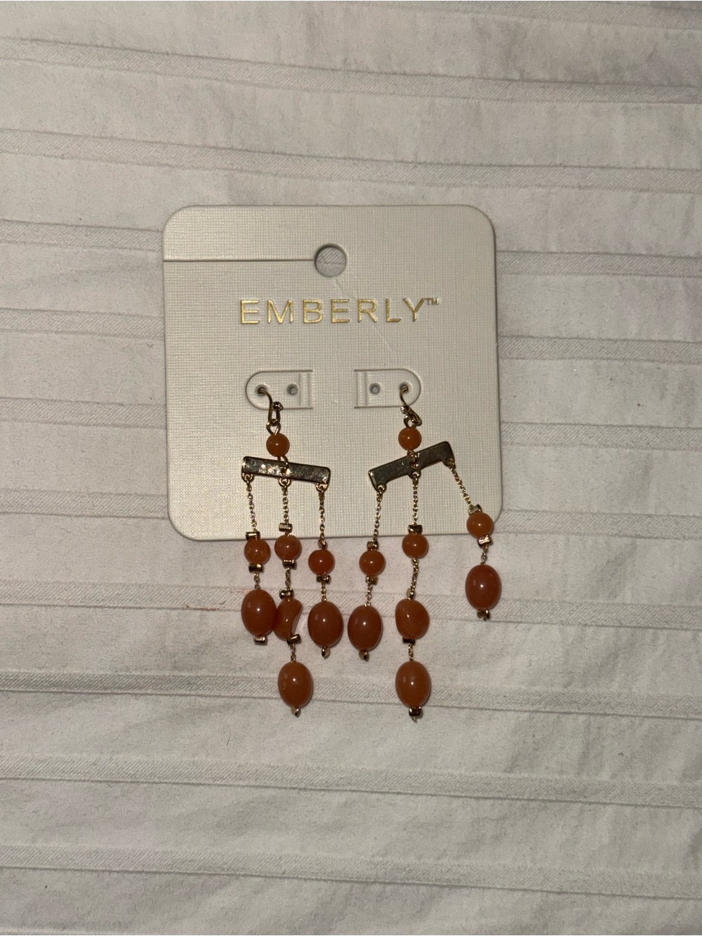 Emberly gold-toned chandelier earrings feature orange beaded dangles